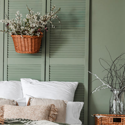 bedroom wall and slat door headboard painted in Agate Green 