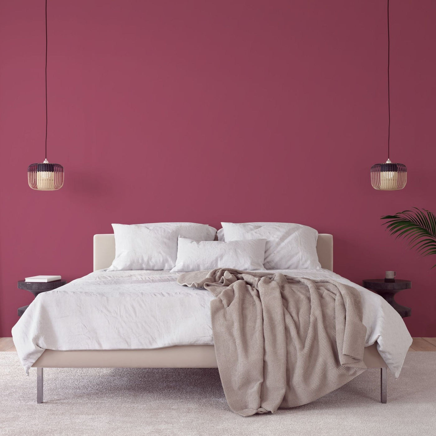 Bedroom with light and airy bedsheets and a vibrant painted wall in the color Cherry Berry
