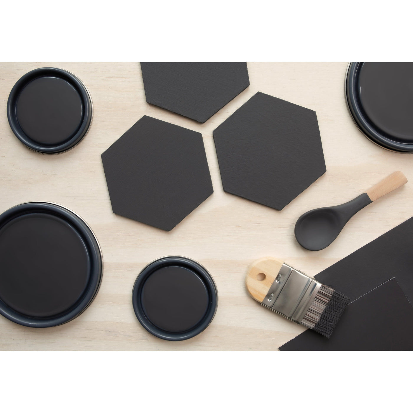flatlay with wood hexagons, small paint brush, paint lids and wooden spoons all painted in Celluloid