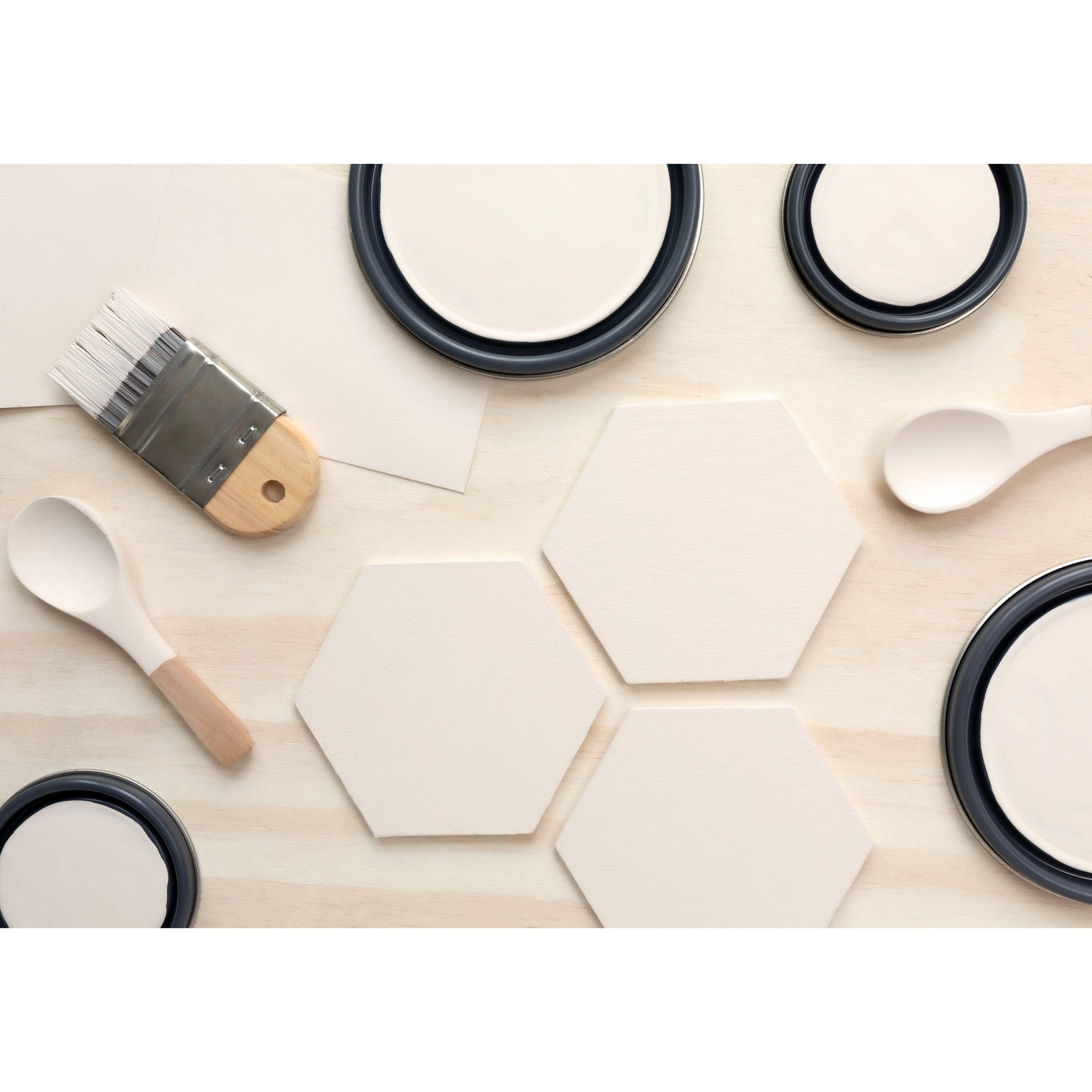 flatlay with wood hexagons, small paint brush, paint lids and wooden spoons all painted in Finest Silk