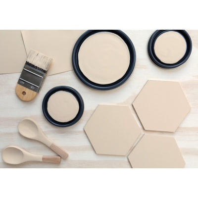 flatlay with wood hexagons, small paint brush, paint lids and wooden spoons all painted in Cameo Role