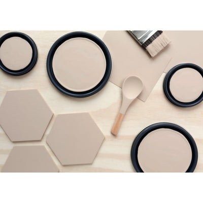 flatlay with wood hexagons, small paint brush, paint lids and wooden spoons all painted in Dry Creek