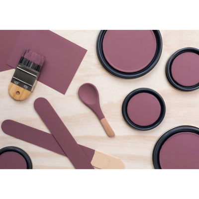 flatlay with paint lids, small paint brush, wooded spoons and rounded sticks painted in Bohemian Jazz