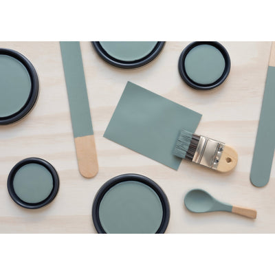 paint lids, small paint brush, wooded spoons and rounded sticks painted in Agate Green