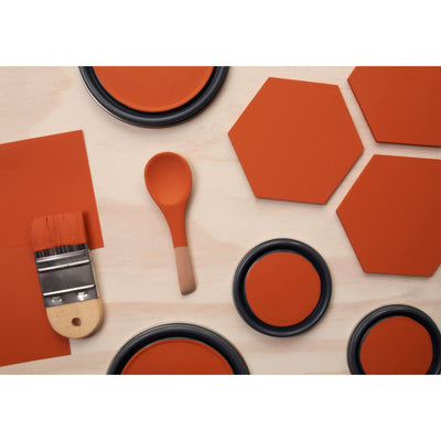 flatlay with wood hexagons, small paint brush, paint lids and wooden spoons all painted in Citrus Notes